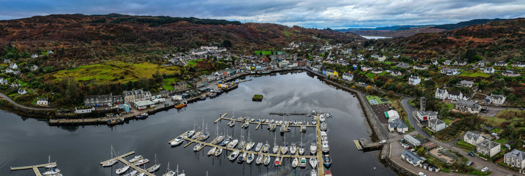 a an aerial view of the picturesque Tarbert Harbour in the village of Tarbert, Loch Fyne, Argyll, Scotland from the top of a bridge