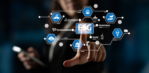 A business professional uses a digital interface to explore ESG elements, highlighting the...