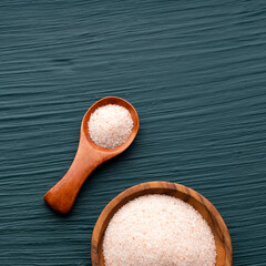 Fine crystals of pink Himalayan salt in a bowl and spoon
