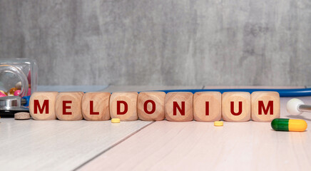 Stethoscope and white card with MELDONIUM text on blue background.