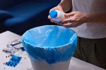 Responsible medication disposal in residential living space, An individual safely discards expired...