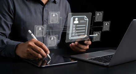 businessman hands using stylus on tablet with resume icons and digital profiles for online recruitment human resources management job search and hiring process on dark background