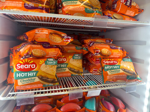 BELO HORIZONTE, MG/BRAZIL, JANUARY, 06, 2026: A refrigerator shelf stocked with Seara Hot Hit Cheddar burgers