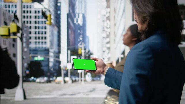 Horizontal isolated screen on smartphone near city crowd of different ages crossing together reflects multicultural motion, daily commute activity and flow of modern street life. Camera A.