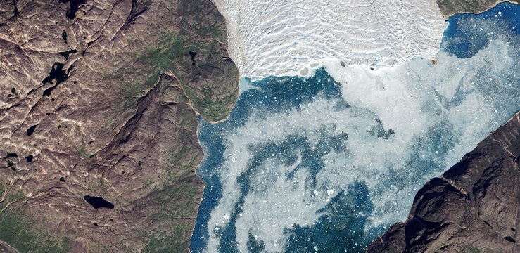 Aerial satellite view of Greenland rocky tundra and melting ice lakes