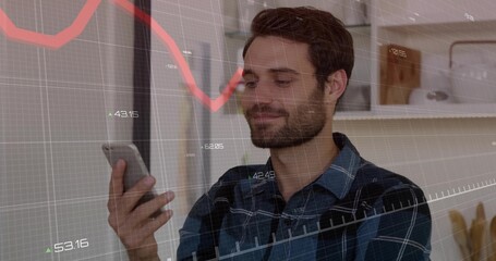 Holding phone, bearded man in blue plaid shirt checking market data at home, with financial overlay
