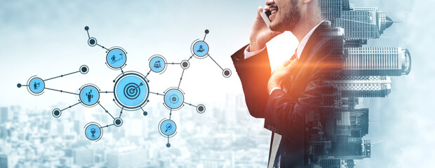 A businessman in a suit engages in a phone call against a digital network backdrop, symbolizing modern communication and connections in a bustling urban setting. Tessel