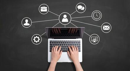 Top view of hands typing on laptop with white chalk icons on blackboard representing business networking human resources social connections management and professional career growth