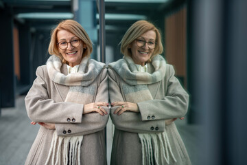 Smiling mature woman reflecting success in urban environment