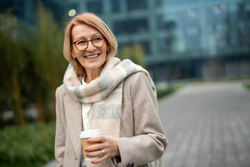 Smiling mature business owner enjoying daily coffee break