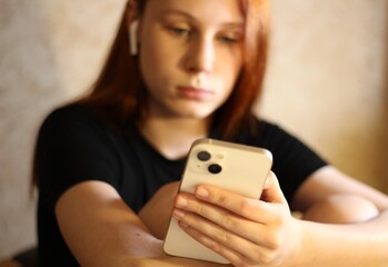 Young teenager pretty girl with smartphone in her hands 