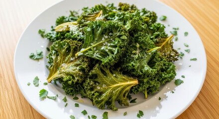 Crispy baked green leafy vegetables seasoned with coarse salt are served on a white dish