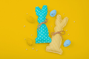 Handmade Easter concept. Sewn textile bunnies with traditional decoration. Festive symbols