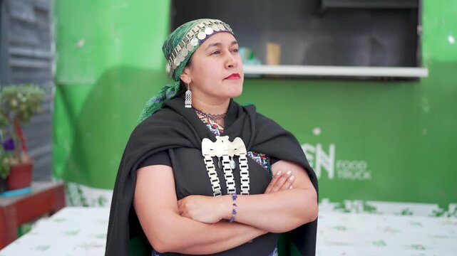 Portrait of a chilean mapuche woman proudly wearing her traditional costume and jewelry