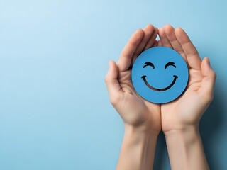 Hands holding a symbol of a happy smiley face