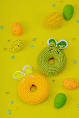 Handmade Easter concept. Crocheted donuts bunnies with traditional decoration. Festive symbols