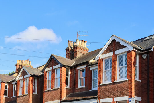 Victorian red brick terraced houses in Hemel Hempstead, England, showing classic architecture and chimneys under a blue sky