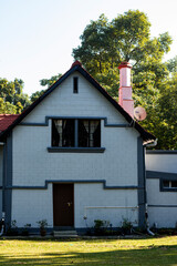White Brick Cottage Wall with Open Windows and Potted Plants