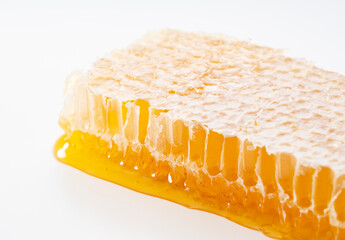 Macro Detail of Fresh Raw Organic Honeycomb with Dripping Liquid Honey on White Background