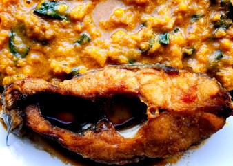 Deep-fried tilapia fish with pumpkin sauce, indoor Chiangmai Thailand.