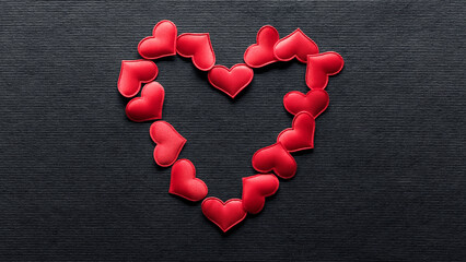 Heart of shiny red hearts on black background. Heart shape for a romantic theme celebrating love, passion, or for a Valentines day background.