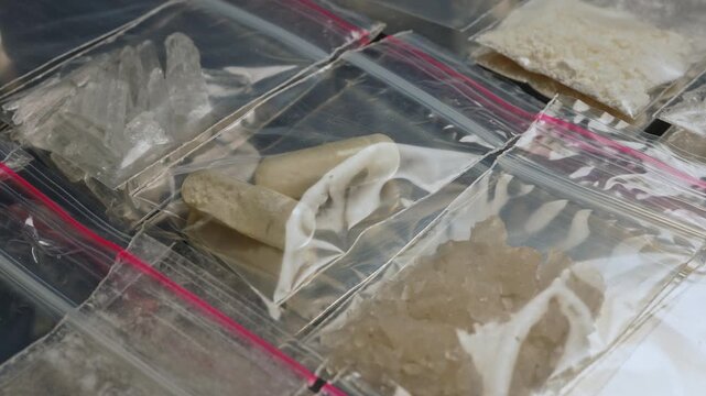 Fentanyl, nitazenes, heroin and synthetic opioid drugs smuggling displayed in small packages concept. Powder, crystals and capsules form causes severe drug crisis in the world.