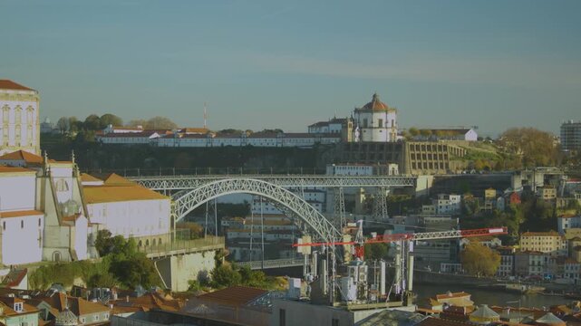 Traditional narrow street with stone houses in Porto, Dom Luis I Bridge with city skyline in Porto