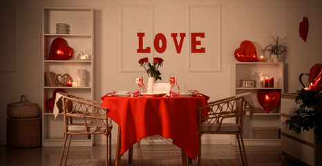Interior of festive living room with served table and decorations for Valentine's Day celebration...