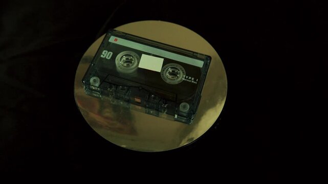 Retro audio tape rotating on a display stand.