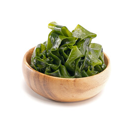 Seaweed wakame in wood bowl on white background.