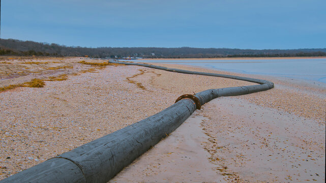 A long Dredging  pipes on the beach