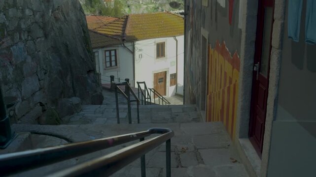 Old narrow street with stairs in a traditional Porto neighborhood.