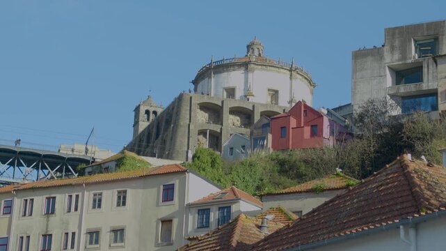Hilltop church and traditional houses forming a scenic Porto city view.