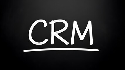 Handwritten abbreviation crm symbolizing customer relationship management strategy concept development written in white chalk on a dark blackboard surface for marketing.