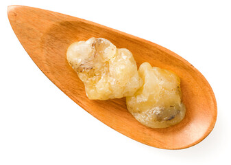 Gum elemi in the wooden plate, isolated on white background, top view.