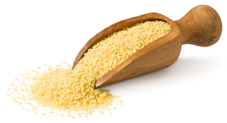 Uncooked couscous in the wooden scoop, isolated on white background.