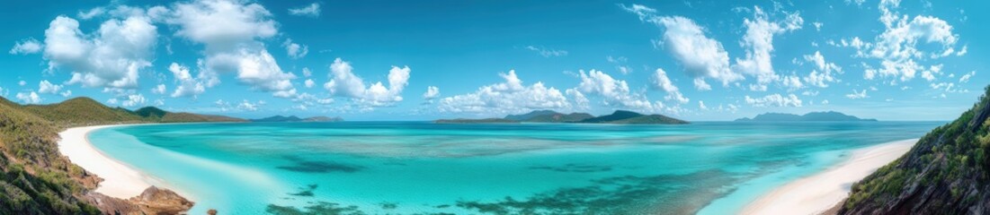 Obraz premium A stunning panoramic view of a tropical beach featuring turquoise waters, white sandy shores, and a clear blue sky with scattered clouds.