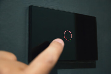 Finger touching digital smart home light switch panel