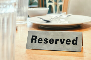 Reserved sign on wooden table in restaurant