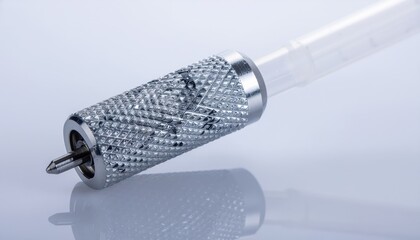 Close-up of a therapeutic apheresis collection device showing a centrifuge separator and knurled grip details in a sterile medical environment.