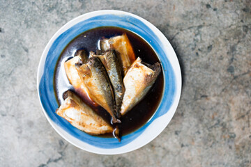Stewed Thai Mackerel, gently boiled in soy sauce and infused with aromatic herbs for a deliciously tender and flavorful dish. Traditional and famous food in Thailand.