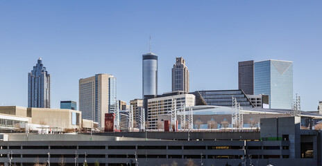 View of the Atlanta skyline showing several prominent buildings, hotels, office towers on a sunny day.