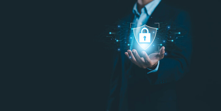 Cyber security concept with businessman holding digital shield and lock icon data protection and network security technology, information safety privacy protection secure system and online protection. - Powered by Adobe