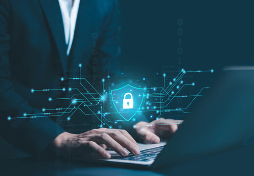 Cyber security and data protection concept with businessman typing on laptop and digital shield lock interface, network security, encrypted connection, information safety, privacy protection.