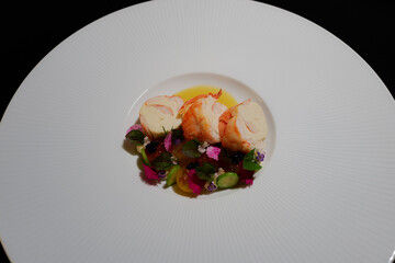 An exquisitely presented dish of lobster with fresh, colorful ingredients