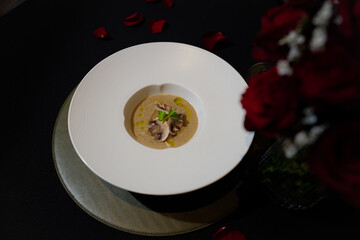 A culinary masterpiece: Mushroom soup, elegantly presented with floral accents