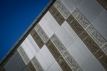  A diagonal detail of the monochrome striped, metal facade of a new parking building - horizontal