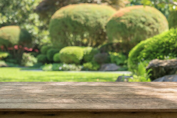 Empty wood table top with abstract blur park garden background