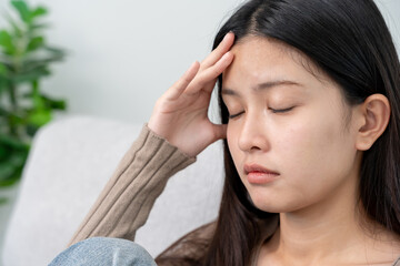 Suffer from headache desperate and stressed because pain and migraine. asian young man suffering migraine pain while working, brain tumor, high cholesterol effect, depression