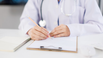 Close up hand of asian female doctor work in medical clinic hospital adviser collecting information writing prescription presenting results examination preventive care healthcare services consultation